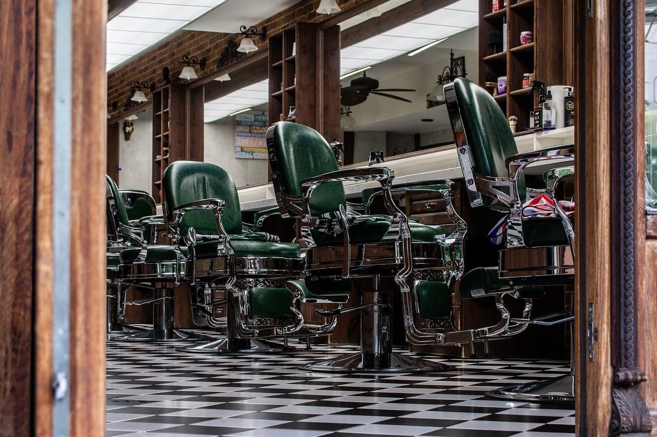 Barber chairs in a row on a chequered floor