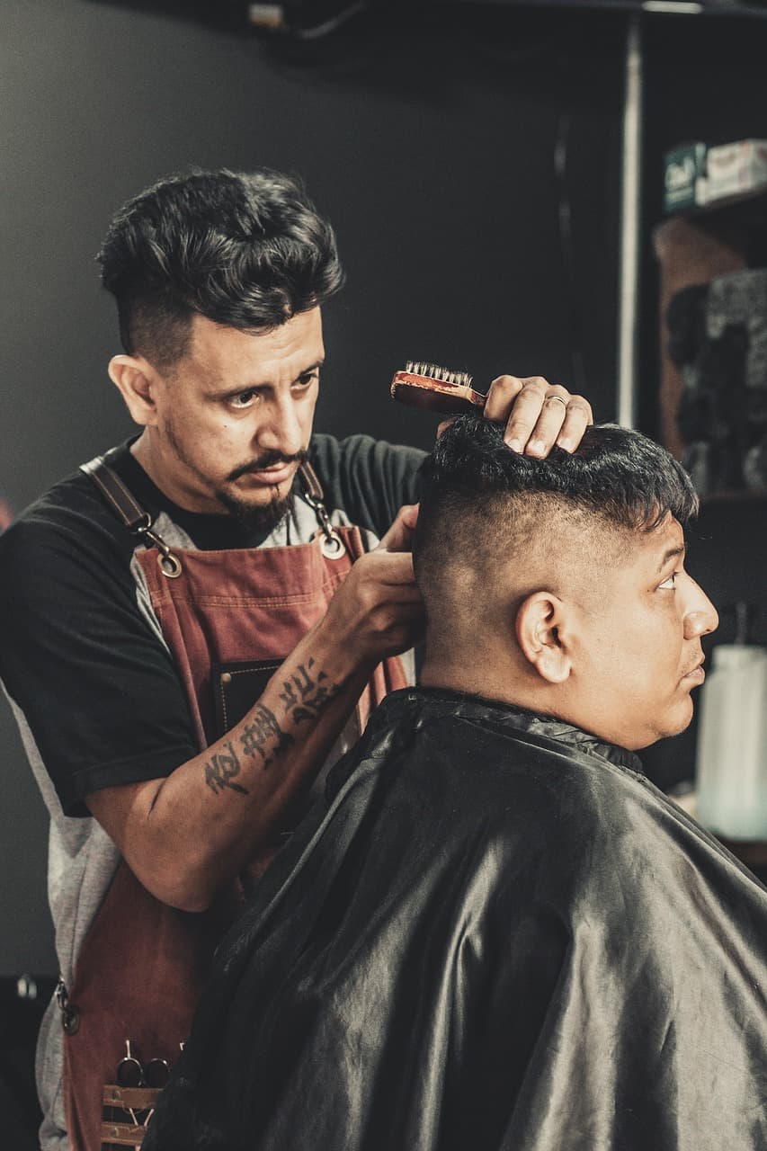 A barber combing through a fresh cut